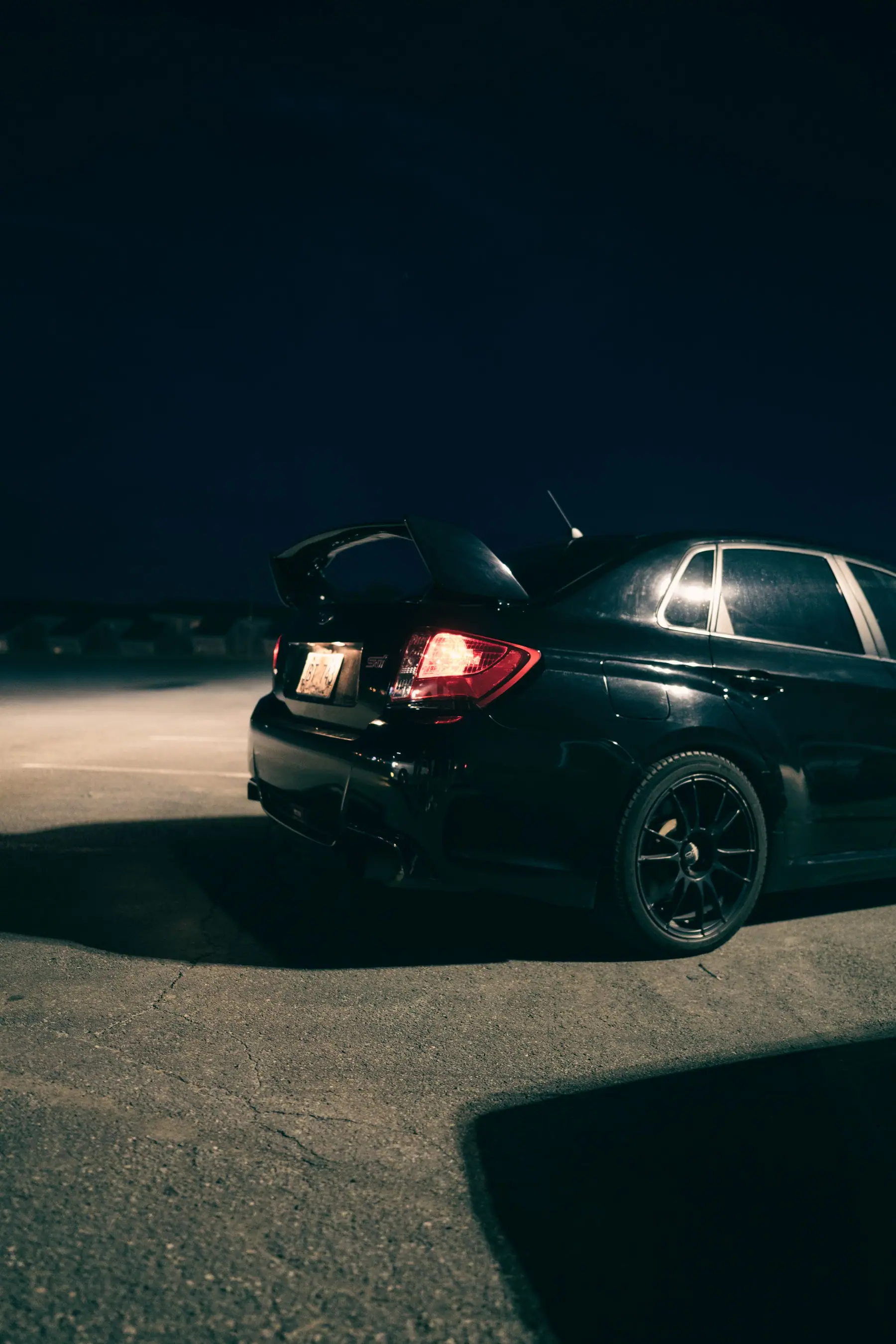 A clean black car at night